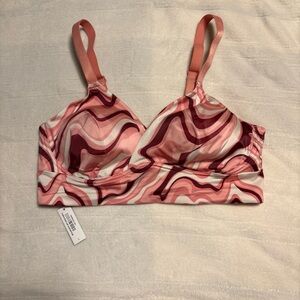 Adore Me Kali low-impact sports bra in a pink, maroon, and white swirl print L
